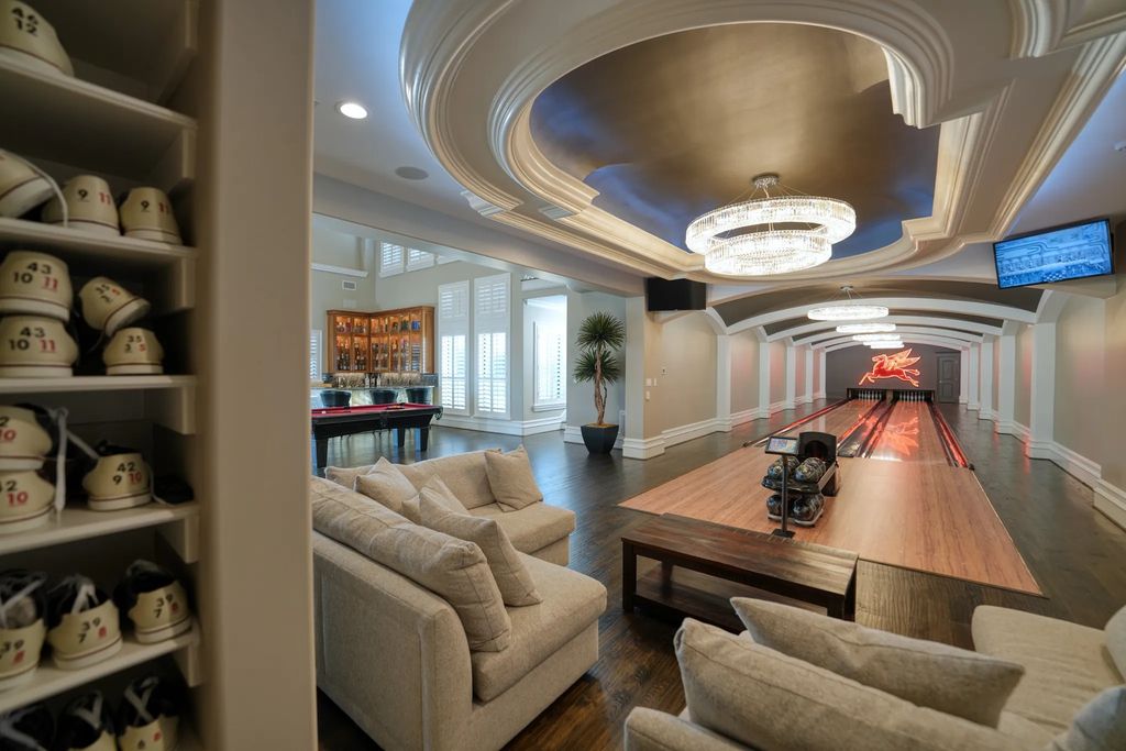 1252 Wales Drive Home in Rockwall, Texas. Step into luxury living at its finest with this illustrious estate set on over two private acres. Enjoy resort-style amenities including a pool with swim-up bar, fire features, waterfalls, and a covered patio with motorized screens.
