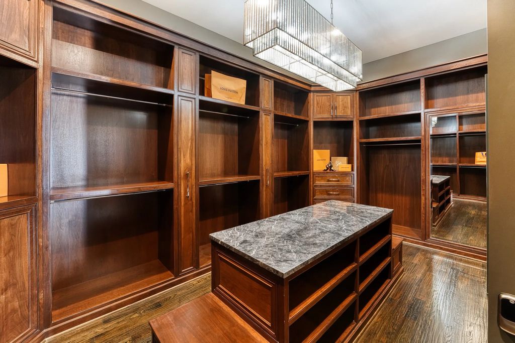 1252 Wales Drive Home in Rockwall, Texas. Step into luxury living at its finest with this illustrious estate set on over two private acres. Enjoy resort-style amenities including a pool with swim-up bar, fire features, waterfalls, and a covered patio with motorized screens.