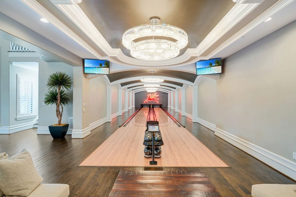 1252 Wales Drive Home in Rockwall, Texas. Step into luxury living at its finest with this illustrious estate set on over two private acres. Enjoy resort-style amenities including a pool with swim-up bar, fire features, waterfalls, and a covered patio with motorized screens.