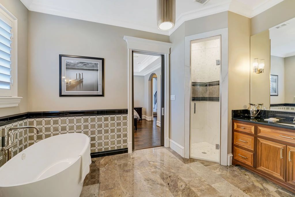 1252 Wales Drive Home in Rockwall, Texas. Step into luxury living at its finest with this illustrious estate set on over two private acres. Enjoy resort-style amenities including a pool with swim-up bar, fire features, waterfalls, and a covered patio with motorized screens.