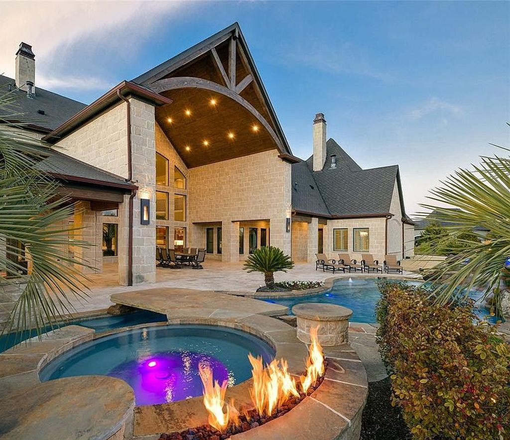 1252 Wales Drive Home in Rockwall, Texas. Step into luxury living at its finest with this illustrious estate set on over two private acres. Enjoy resort-style amenities including a pool with swim-up bar, fire features, waterfalls, and a covered patio with motorized screens.