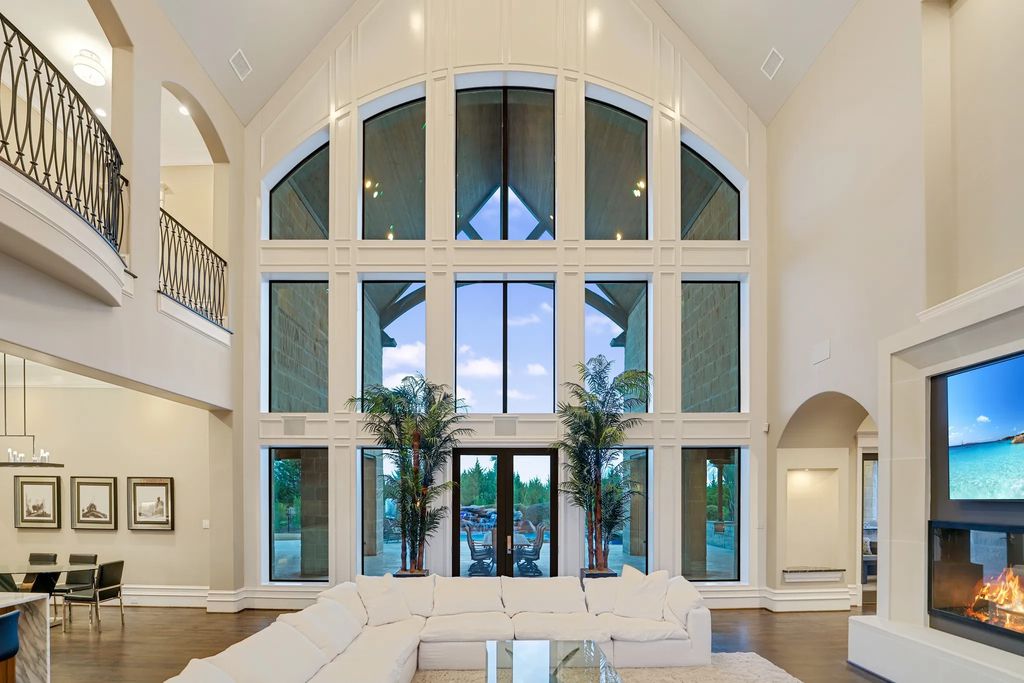 1252 Wales Drive Home in Rockwall, Texas. Step into luxury living at its finest with this illustrious estate set on over two private acres. Enjoy resort-style amenities including a pool with swim-up bar, fire features, waterfalls, and a covered patio with motorized screens.