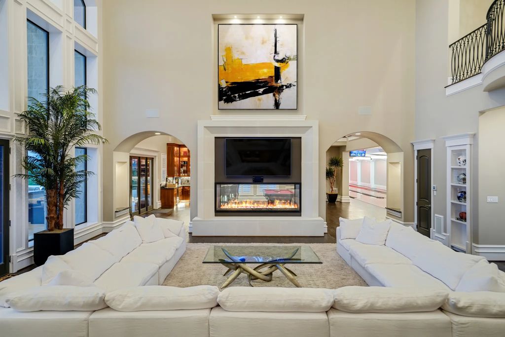 1252 Wales Drive Home in Rockwall, Texas. Step into luxury living at its finest with this illustrious estate set on over two private acres. Enjoy resort-style amenities including a pool with swim-up bar, fire features, waterfalls, and a covered patio with motorized screens.
