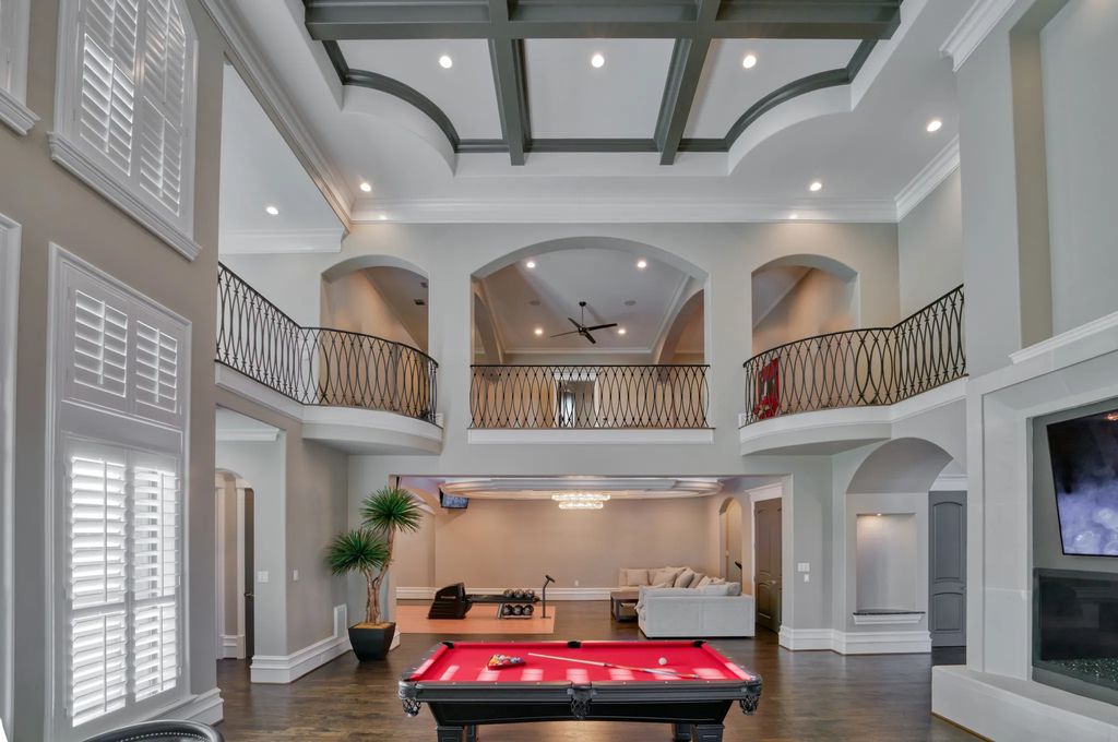 1252 Wales Drive Home in Rockwall, Texas. Step into luxury living at its finest with this illustrious estate set on over two private acres. Enjoy resort-style amenities including a pool with swim-up bar, fire features, waterfalls, and a covered patio with motorized screens.