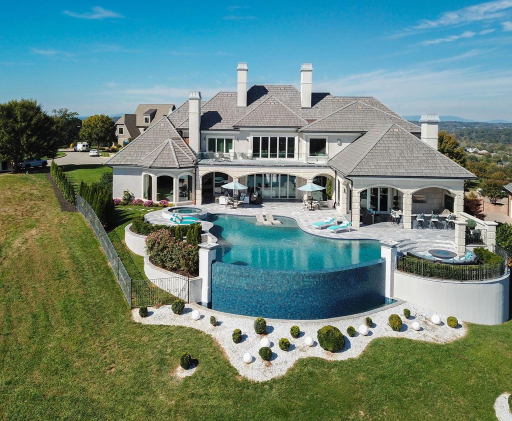 12768 Highwick Circle Home in Knoxville, Tennessee. Explore the epitome of luxury living at this architectural masterpiece nestled in prestigious Bridgemore. Perched atop Farragut's highest point, this one-of-a-kind home offers breathtaking views of the mountains and lake. 