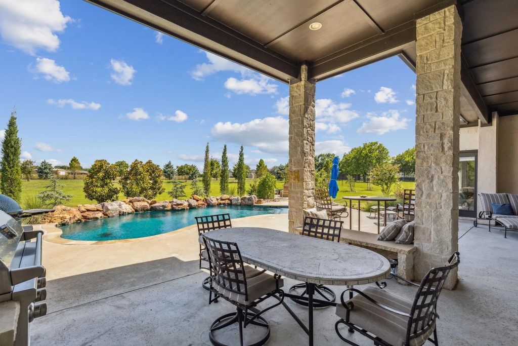 1621 Jan Marie Drive Home in Lucas, Texas. Discover unparalleled luxury in this custom J. Anthony home quietly nestled on a 2-acre north-facing cul-de-sac in prestigious Lovejoy ISD. Featuring exceptional design, premium fixtures, and abundant natural light, this home offers an open concept living area with exposed beams and a gourmet kitchen with dual islands and quartz countertops.