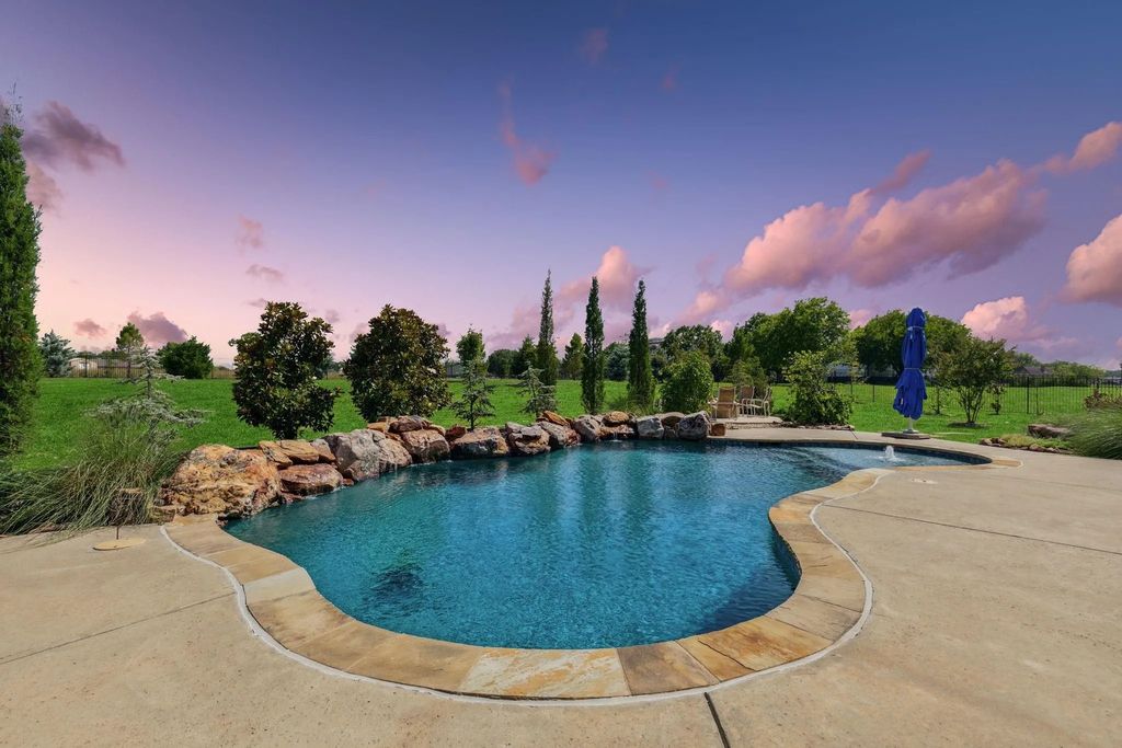 1621 Jan Marie Drive Home in Lucas, Texas. Discover unparalleled luxury in this custom J. Anthony home quietly nestled on a 2-acre north-facing cul-de-sac in prestigious Lovejoy ISD. Featuring exceptional design, premium fixtures, and abundant natural light, this home offers an open concept living area with exposed beams and a gourmet kitchen with dual islands and quartz countertops.