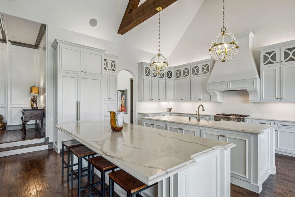 1621 Jan Marie Drive Home in Lucas, Texas. Discover unparalleled luxury in this custom J. Anthony home quietly nestled on a 2-acre north-facing cul-de-sac in prestigious Lovejoy ISD. Featuring exceptional design, premium fixtures, and abundant natural light, this home offers an open concept living area with exposed beams and a gourmet kitchen with dual islands and quartz countertops.