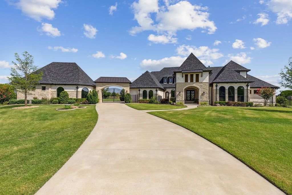 1621 Jan Marie Drive Home in Lucas, Texas. Discover unparalleled luxury in this custom J. Anthony home quietly nestled on a 2-acre north-facing cul-de-sac in prestigious Lovejoy ISD. Featuring exceptional design, premium fixtures, and abundant natural light, this home offers an open concept living area with exposed beams and a gourmet kitchen with dual islands and quartz countertops.