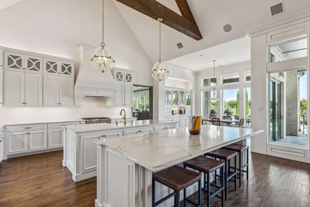 1621 Jan Marie Drive Home in Lucas, Texas. Discover unparalleled luxury in this custom J. Anthony home quietly nestled on a 2-acre north-facing cul-de-sac in prestigious Lovejoy ISD. Featuring exceptional design, premium fixtures, and abundant natural light, this home offers an open concept living area with exposed beams and a gourmet kitchen with dual islands and quartz countertops.