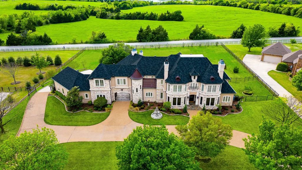920 Broken Lance Lane Home in Rockwall, Texas. Discover the epitome of luxury living in this French-inspired estate nestled within a lakeside community near Dallas amenities. With 61 estate homes in the gated Oaks of Buffalo Way, this property exudes elegance with its wrought-iron porte cochere, NEW roof with copper turret, and 5 fireplaces.