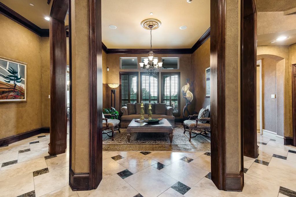 920 Broken Lance Lane Home in Rockwall, Texas. Discover the epitome of luxury living in this French-inspired estate nestled within a lakeside community near Dallas amenities. With 61 estate homes in the gated Oaks of Buffalo Way, this property exudes elegance with its wrought-iron porte cochere, NEW roof with copper turret, and 5 fireplaces.