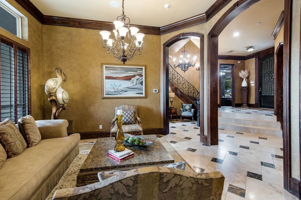 920 Broken Lance Lane Home in Rockwall, Texas. Discover the epitome of luxury living in this French-inspired estate nestled within a lakeside community near Dallas amenities. With 61 estate homes in the gated Oaks of Buffalo Way, this property exudes elegance with its wrought-iron porte cochere, NEW roof with copper turret, and 5 fireplaces.