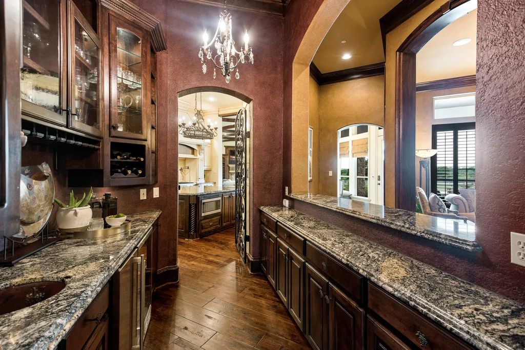920 Broken Lance Lane Home in Rockwall, Texas. Discover the epitome of luxury living in this French-inspired estate nestled within a lakeside community near Dallas amenities. With 61 estate homes in the gated Oaks of Buffalo Way, this property exudes elegance with its wrought-iron porte cochere, NEW roof with copper turret, and 5 fireplaces.
