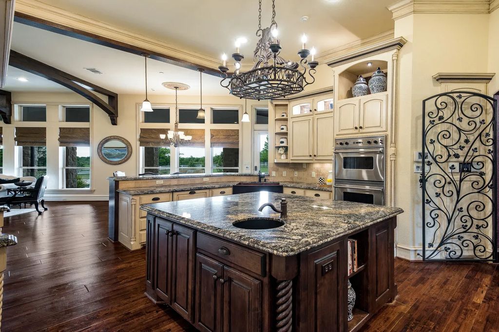 920 Broken Lance Lane Home in Rockwall, Texas. Discover the epitome of luxury living in this French-inspired estate nestled within a lakeside community near Dallas amenities. With 61 estate homes in the gated Oaks of Buffalo Way, this property exudes elegance with its wrought-iron porte cochere, NEW roof with copper turret, and 5 fireplaces.