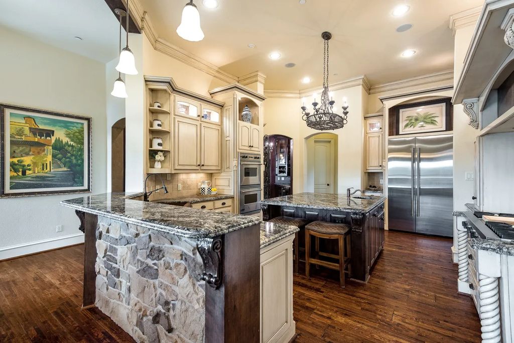 920 Broken Lance Lane Home in Rockwall, Texas. Discover the epitome of luxury living in this French-inspired estate nestled within a lakeside community near Dallas amenities. With 61 estate homes in the gated Oaks of Buffalo Way, this property exudes elegance with its wrought-iron porte cochere, NEW roof with copper turret, and 5 fireplaces.
