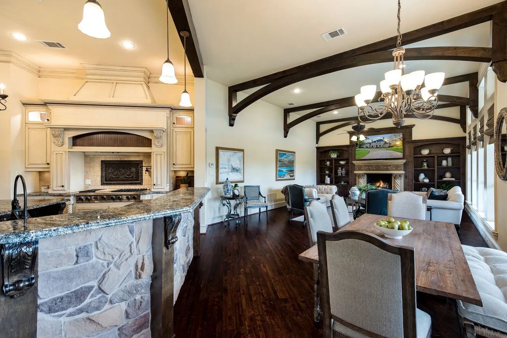 920 Broken Lance Lane Home in Rockwall, Texas. Discover the epitome of luxury living in this French-inspired estate nestled within a lakeside community near Dallas amenities. With 61 estate homes in the gated Oaks of Buffalo Way, this property exudes elegance with its wrought-iron porte cochere, NEW roof with copper turret, and 5 fireplaces.