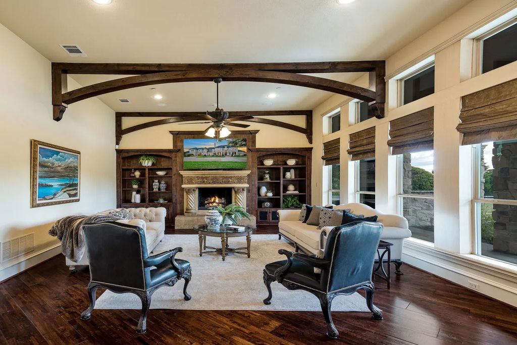 920 Broken Lance Lane Home in Rockwall, Texas. Discover the epitome of luxury living in this French-inspired estate nestled within a lakeside community near Dallas amenities. With 61 estate homes in the gated Oaks of Buffalo Way, this property exudes elegance with its wrought-iron porte cochere, NEW roof with copper turret, and 5 fireplaces.