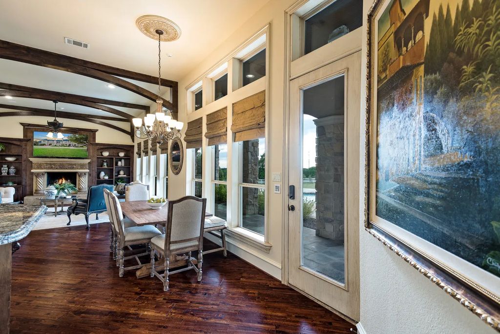 920 Broken Lance Lane Home in Rockwall, Texas. Discover the epitome of luxury living in this French-inspired estate nestled within a lakeside community near Dallas amenities. With 61 estate homes in the gated Oaks of Buffalo Way, this property exudes elegance with its wrought-iron porte cochere, NEW roof with copper turret, and 5 fireplaces.