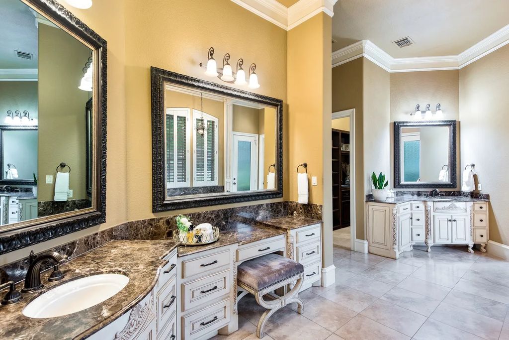 920 Broken Lance Lane Home in Rockwall, Texas. Discover the epitome of luxury living in this French-inspired estate nestled within a lakeside community near Dallas amenities. With 61 estate homes in the gated Oaks of Buffalo Way, this property exudes elegance with its wrought-iron porte cochere, NEW roof with copper turret, and 5 fireplaces.