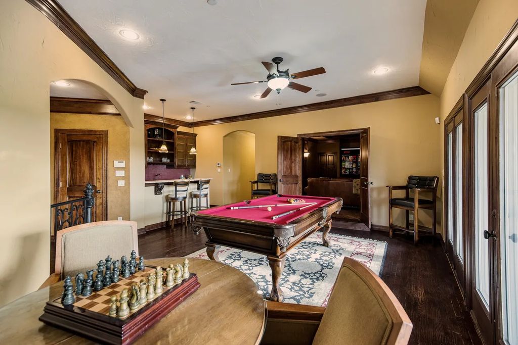 920 Broken Lance Lane Home in Rockwall, Texas. Discover the epitome of luxury living in this French-inspired estate nestled within a lakeside community near Dallas amenities. With 61 estate homes in the gated Oaks of Buffalo Way, this property exudes elegance with its wrought-iron porte cochere, NEW roof with copper turret, and 5 fireplaces.