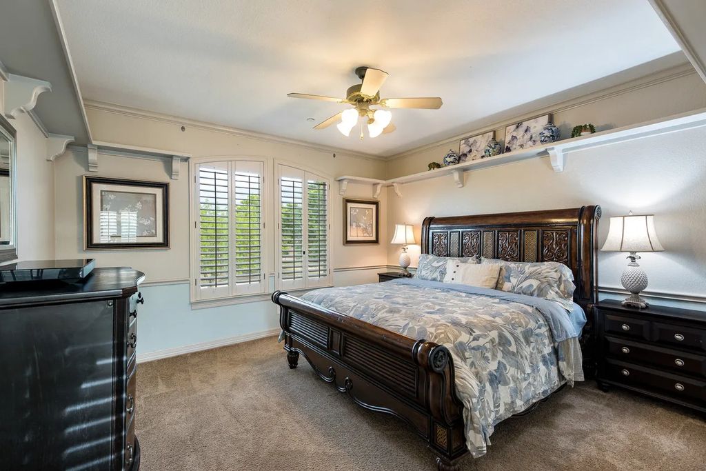 920 Broken Lance Lane Home in Rockwall, Texas. Discover the epitome of luxury living in this French-inspired estate nestled within a lakeside community near Dallas amenities. With 61 estate homes in the gated Oaks of Buffalo Way, this property exudes elegance with its wrought-iron porte cochere, NEW roof with copper turret, and 5 fireplaces.
