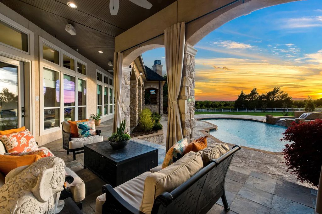 920 Broken Lance Lane Home in Rockwall, Texas. Discover the epitome of luxury living in this French-inspired estate nestled within a lakeside community near Dallas amenities. With 61 estate homes in the gated Oaks of Buffalo Way, this property exudes elegance with its wrought-iron porte cochere, NEW roof with copper turret, and 5 fireplaces.