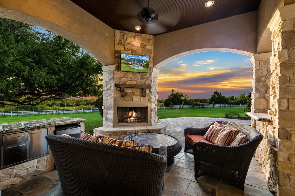 920 Broken Lance Lane Home in Rockwall, Texas. Discover the epitome of luxury living in this French-inspired estate nestled within a lakeside community near Dallas amenities. With 61 estate homes in the gated Oaks of Buffalo Way, this property exudes elegance with its wrought-iron porte cochere, NEW roof with copper turret, and 5 fireplaces.