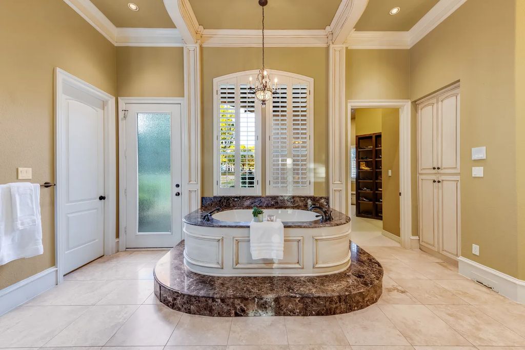 920 Broken Lance Lane Home in Rockwall, Texas. Discover the epitome of luxury living in this French-inspired estate nestled within a lakeside community near Dallas amenities. With 61 estate homes in the gated Oaks of Buffalo Way, this property exudes elegance with its wrought-iron porte cochere, NEW roof with copper turret, and 5 fireplaces.