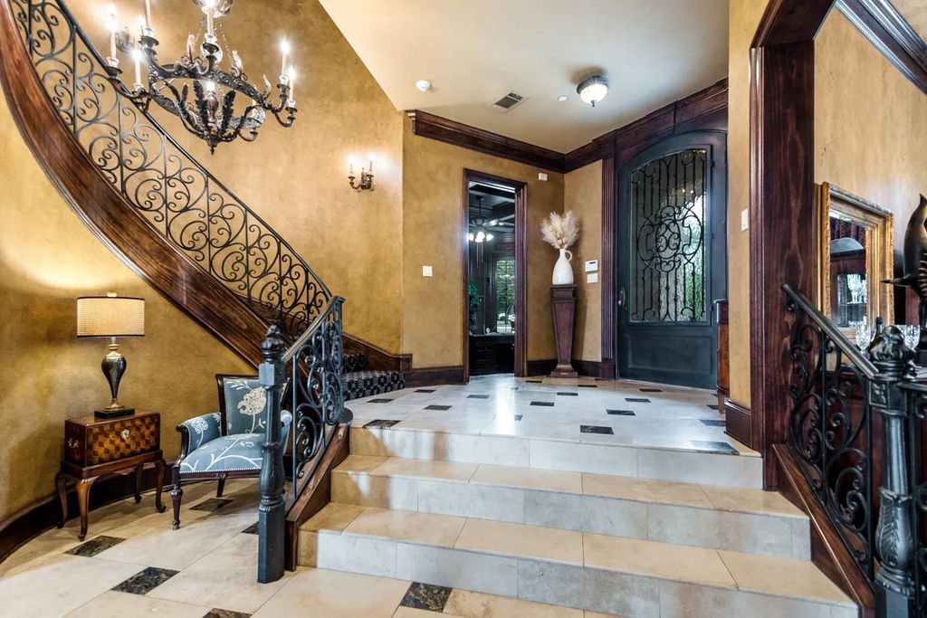920 Broken Lance Lane Home in Rockwall, Texas. Discover the epitome of luxury living in this French-inspired estate nestled within a lakeside community near Dallas amenities. With 61 estate homes in the gated Oaks of Buffalo Way, this property exudes elegance with its wrought-iron porte cochere, NEW roof with copper turret, and 5 fireplaces.