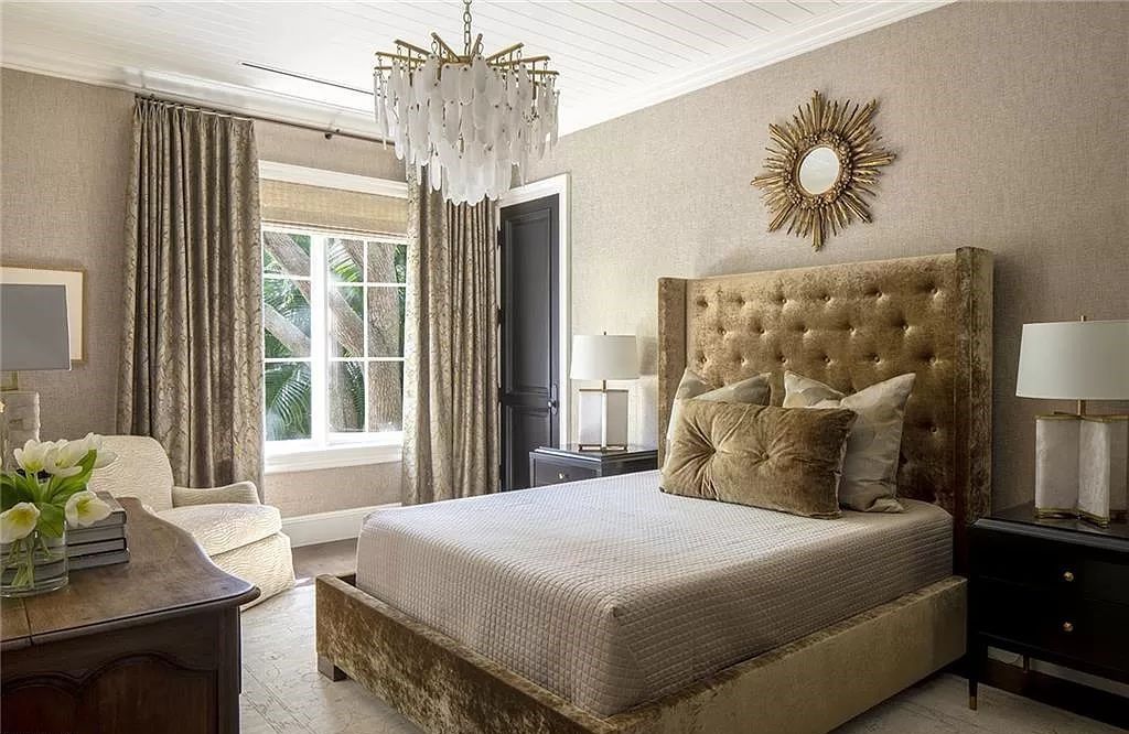 Nestled along Champney Bay in Naples, Florida, this meticulously renovated French West Indies-style estate, crafted by architect Jeff Harrell and updated by the esteemed Knauf-Koenig Group, offers a seamless blend of timeless elegance and modern luxury.