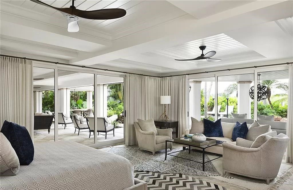 Nestled along Champney Bay in Naples, Florida, this meticulously renovated French West Indies-style estate, crafted by architect Jeff Harrell and updated by the esteemed Knauf-Koenig Group, offers a seamless blend of timeless elegance and modern luxury.