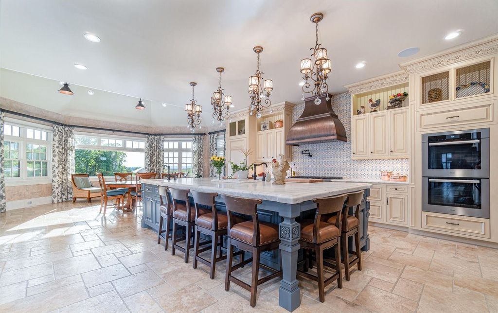 65 Brown Road Home in Stillwater, New York. Experience unparalleled luxury in this exquisite French Country Chateau nestled on 15 acres with stunning views of Saratoga Lake. Boasting 7,237 SF, this custom mansion features 5 bedroom suites, 7.5 baths, and a separate pool house with kitchenette, bathroom, and fireplace. 