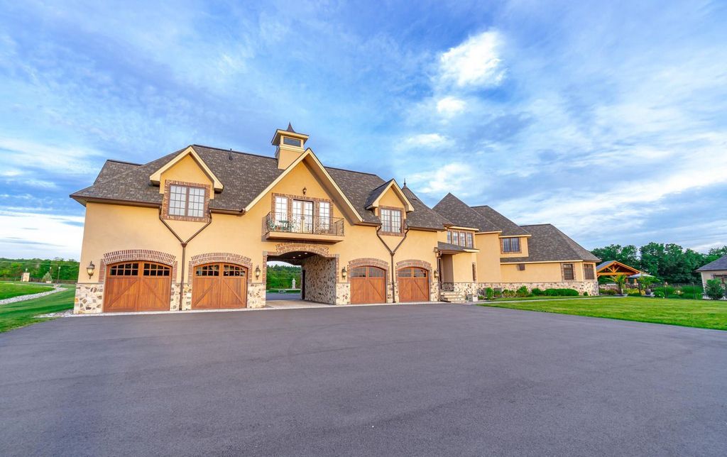 65 Brown Road Home in Stillwater, New York. Experience unparalleled luxury in this exquisite French Country Chateau nestled on 15 acres with stunning views of Saratoga Lake. Boasting 7,237 SF, this custom mansion features 5 bedroom suites, 7.5 baths, and a separate pool house with kitchenette, bathroom, and fireplace. 