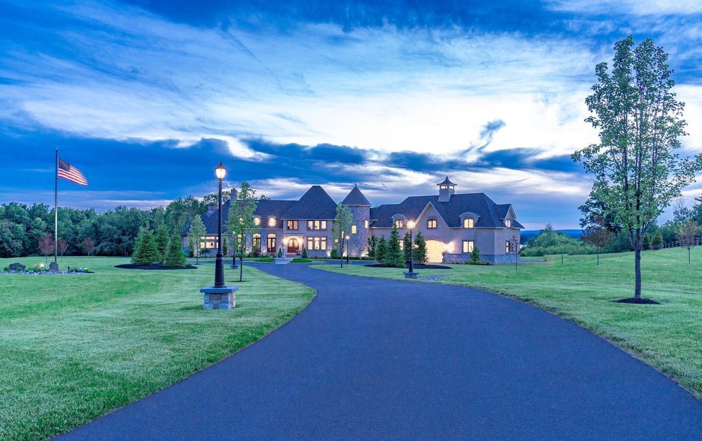 65 Brown Road Home in Stillwater, New York. Experience unparalleled luxury in this exquisite French Country Chateau nestled on 15 acres with stunning views of Saratoga Lake. Boasting 7,237 SF, this custom mansion features 5 bedroom suites, 7.5 baths, and a separate pool house with kitchenette, bathroom, and fireplace. 