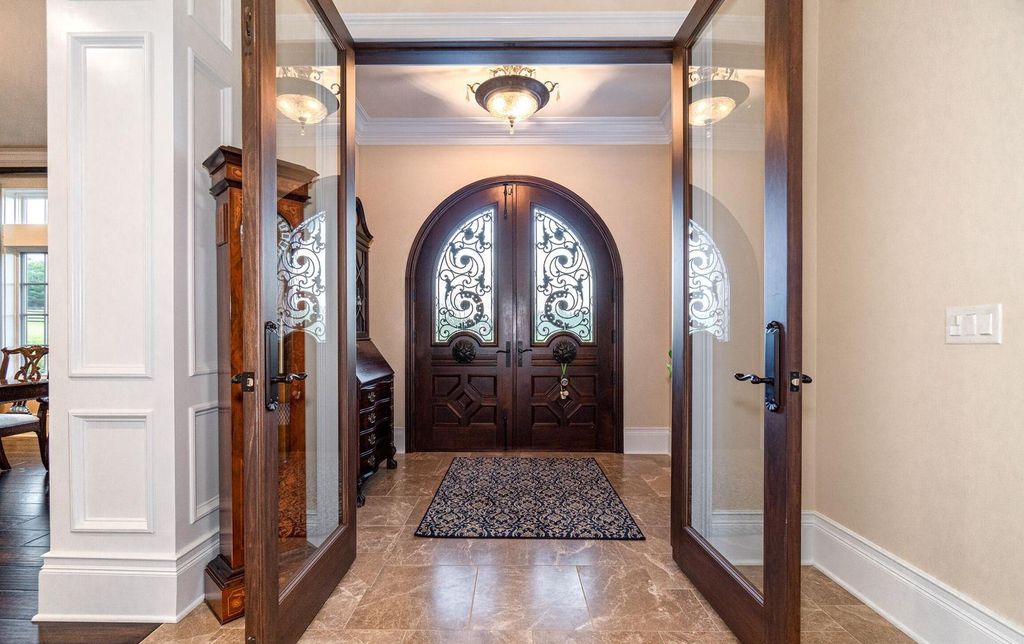 65 Brown Road Home in Stillwater, New York. Experience unparalleled luxury in this exquisite French Country Chateau nestled on 15 acres with stunning views of Saratoga Lake. Boasting 7,237 SF, this custom mansion features 5 bedroom suites, 7.5 baths, and a separate pool house with kitchenette, bathroom, and fireplace. 
