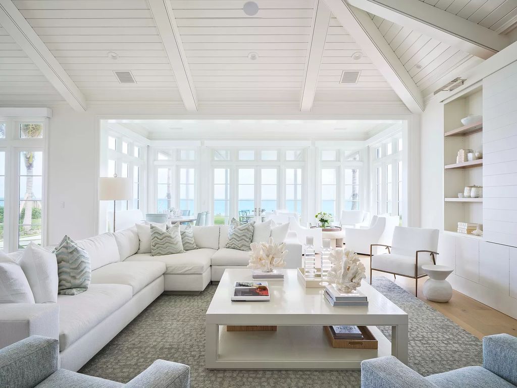 Welcome to 11432 Turtle Beach Road, an exquisite oceanfront property in North Palm Beach, FL, offering 7 bedrooms, 7 bathrooms, and 7,823 square feet of luxury living space on a sprawling 0.80-acre lot. This meticulously renovated home seamlessly blends elegance with casual beach living, featuring separate guest and living quarters that capture both east and west exposures, inviting ocean breezes, and abundant natural light