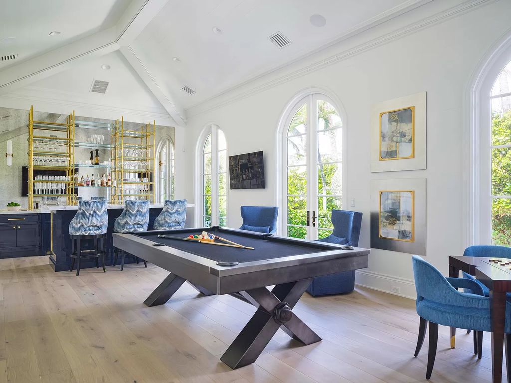 Welcome to 11432 Turtle Beach Road, an exquisite oceanfront property in North Palm Beach, FL, offering 7 bedrooms, 7 bathrooms, and 7,823 square feet of luxury living space on a sprawling 0.80-acre lot. This meticulously renovated home seamlessly blends elegance with casual beach living, featuring separate guest and living quarters that capture both east and west exposures, inviting ocean breezes, and abundant natural light