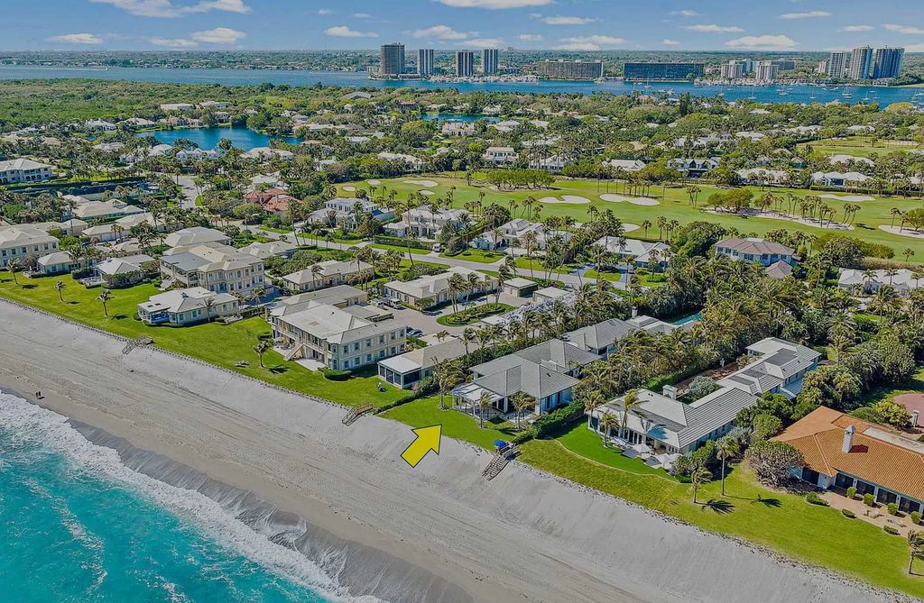 Welcome to 11432 Turtle Beach Road, an exquisite oceanfront property in North Palm Beach, FL, offering 7 bedrooms, 7 bathrooms, and 7,823 square feet of luxury living space on a sprawling 0.80-acre lot. This meticulously renovated home seamlessly blends elegance with casual beach living, featuring separate guest and living quarters that capture both east and west exposures, inviting ocean breezes, and abundant natural light