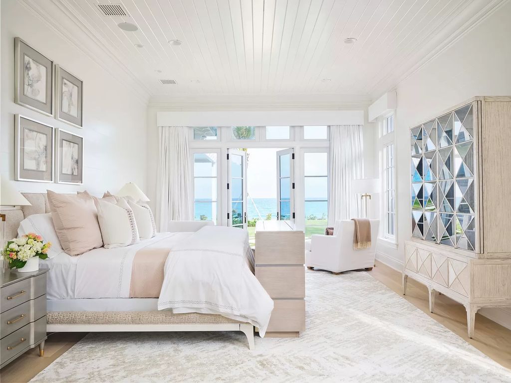 Welcome to 11432 Turtle Beach Road, an exquisite oceanfront property in North Palm Beach, FL, offering 7 bedrooms, 7 bathrooms, and 7,823 square feet of luxury living space on a sprawling 0.80-acre lot. This meticulously renovated home seamlessly blends elegance with casual beach living, featuring separate guest and living quarters that capture both east and west exposures, inviting ocean breezes, and abundant natural light