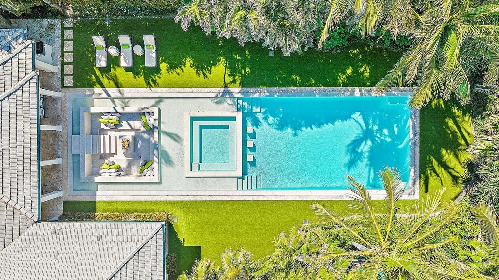 Welcome to 11432 Turtle Beach Road, an exquisite oceanfront property in North Palm Beach, FL, offering 7 bedrooms, 7 bathrooms, and 7,823 square feet of luxury living space on a sprawling 0.80-acre lot. This meticulously renovated home seamlessly blends elegance with casual beach living, featuring separate guest and living quarters that capture both east and west exposures, inviting ocean breezes, and abundant natural light