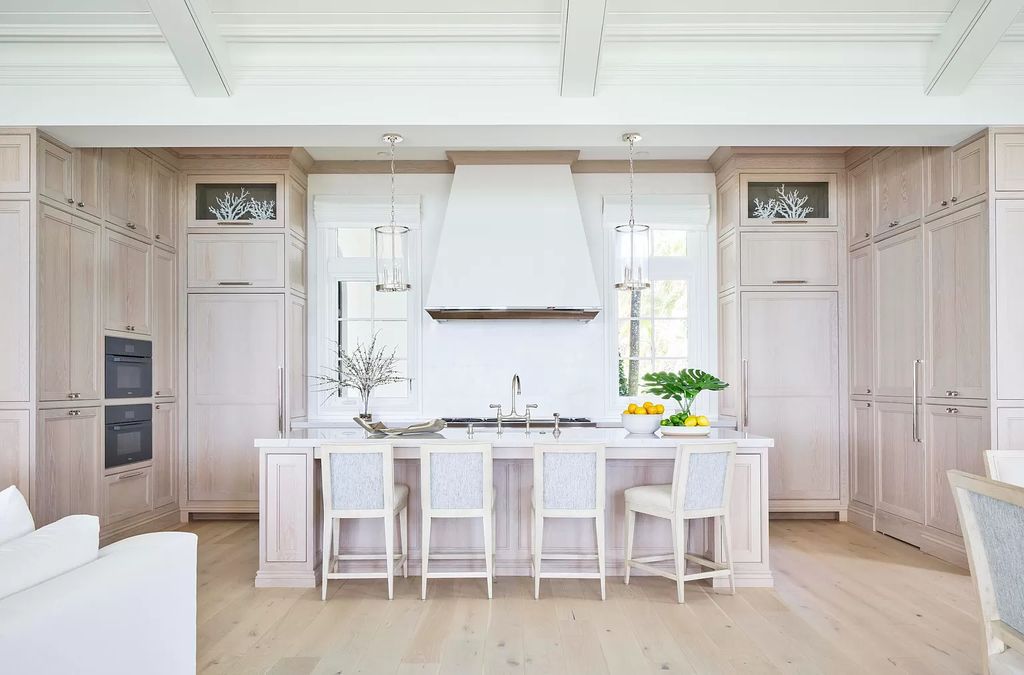 Welcome to 11432 Turtle Beach Road, an exquisite oceanfront property in North Palm Beach, FL, offering 7 bedrooms, 7 bathrooms, and 7,823 square feet of luxury living space on a sprawling 0.80-acre lot. This meticulously renovated home seamlessly blends elegance with casual beach living, featuring separate guest and living quarters that capture both east and west exposures, inviting ocean breezes, and abundant natural light