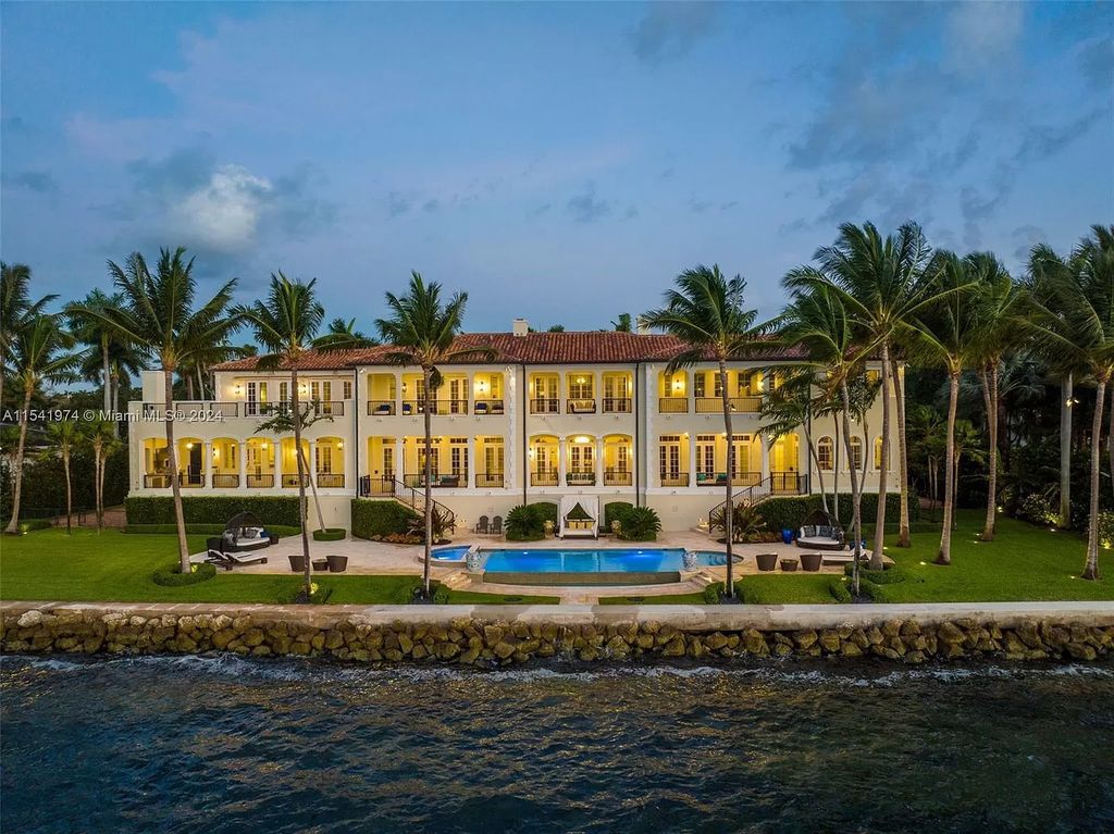 Nestled within the prestigious guard-gated community of Gables Estates, 33 Arvida Parkway presents a magnificent 14,972-square-foot estate boasting 225 feet of waterfront on a lushly landscaped 35,389-square-foot lot.
