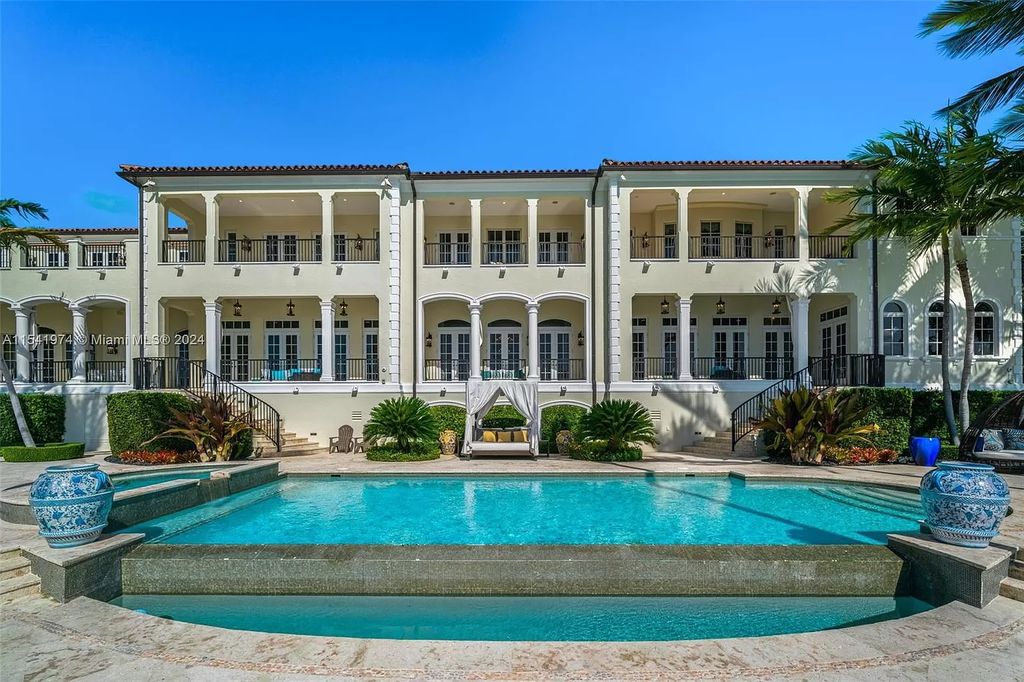 Nestled within the prestigious guard-gated community of Gables Estates, 33 Arvida Parkway presents a magnificent 14,972-square-foot estate boasting 225 feet of waterfront on a lushly landscaped 35,389-square-foot lot.