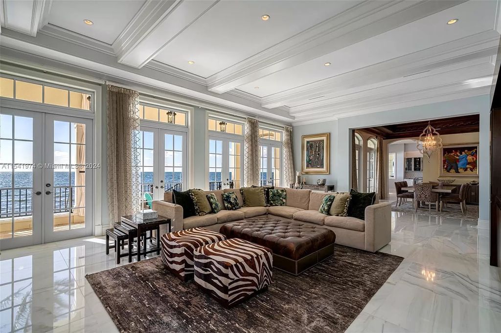 Nestled within the prestigious guard-gated community of Gables Estates, 33 Arvida Parkway presents a magnificent 14,972-square-foot estate boasting 225 feet of waterfront on a lushly landscaped 35,389-square-foot lot.