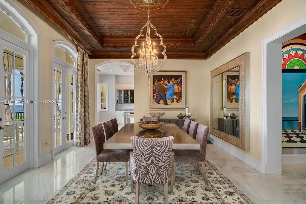 Nestled within the prestigious guard-gated community of Gables Estates, 33 Arvida Parkway presents a magnificent 14,972-square-foot estate boasting 225 feet of waterfront on a lushly landscaped 35,389-square-foot lot.