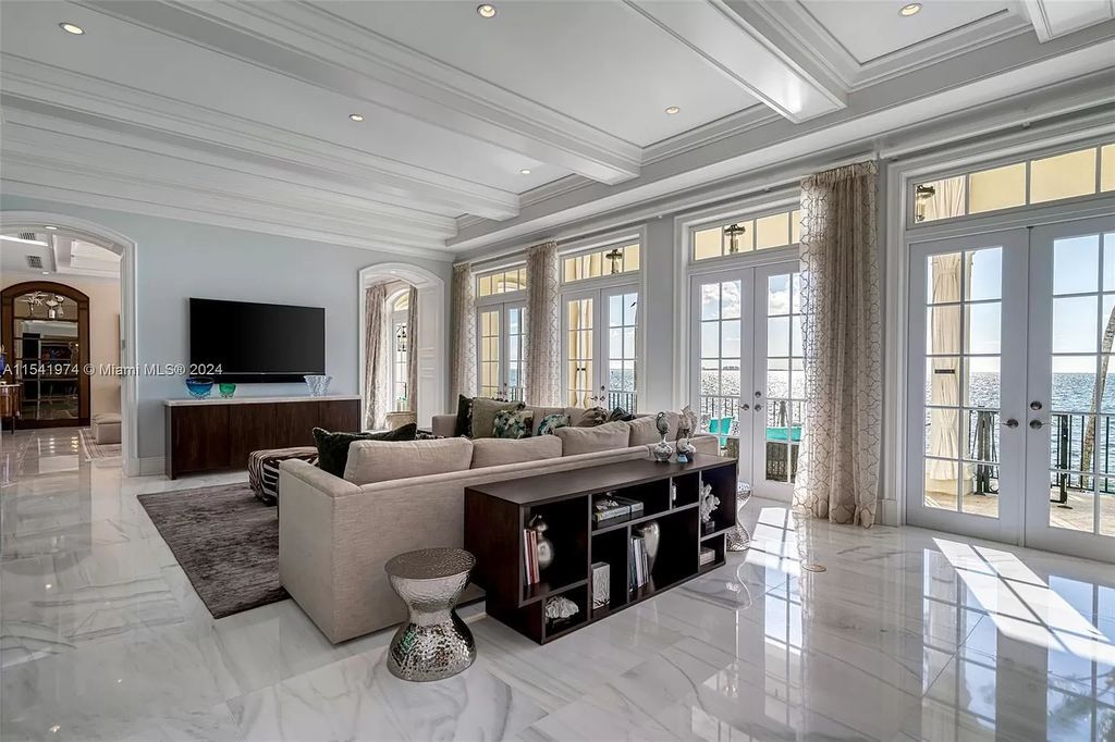 Nestled within the prestigious guard-gated community of Gables Estates, 33 Arvida Parkway presents a magnificent 14,972-square-foot estate boasting 225 feet of waterfront on a lushly landscaped 35,389-square-foot lot.