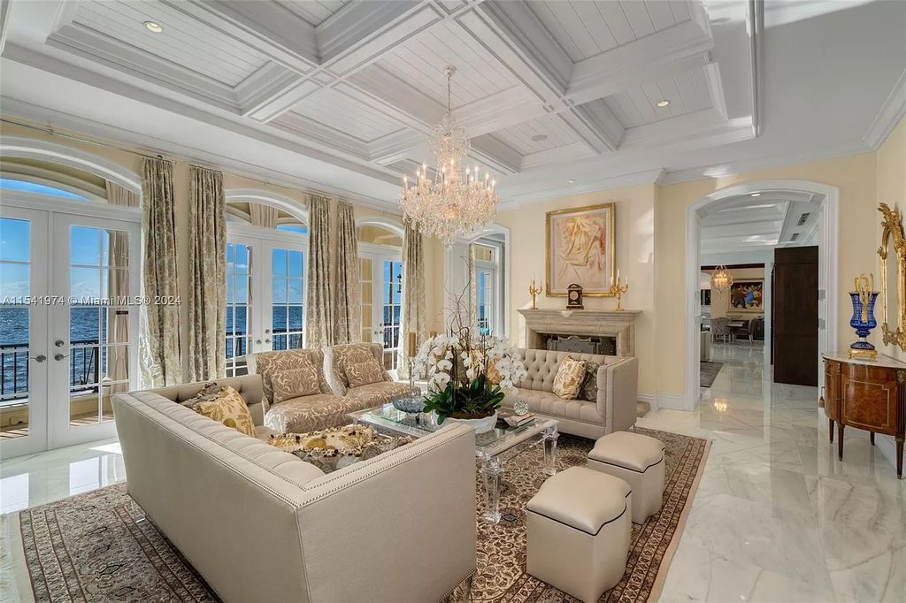 Nestled within the prestigious guard-gated community of Gables Estates, 33 Arvida Parkway presents a magnificent 14,972-square-foot estate boasting 225 feet of waterfront on a lushly landscaped 35,389-square-foot lot.