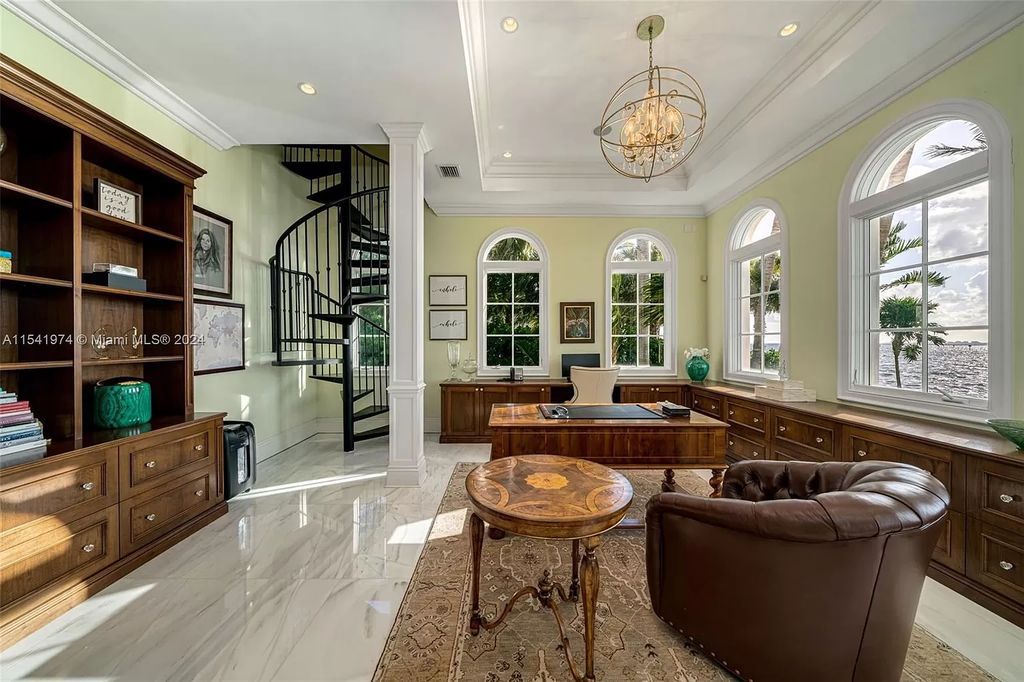 Nestled within the prestigious guard-gated community of Gables Estates, 33 Arvida Parkway presents a magnificent 14,972-square-foot estate boasting 225 feet of waterfront on a lushly landscaped 35,389-square-foot lot.