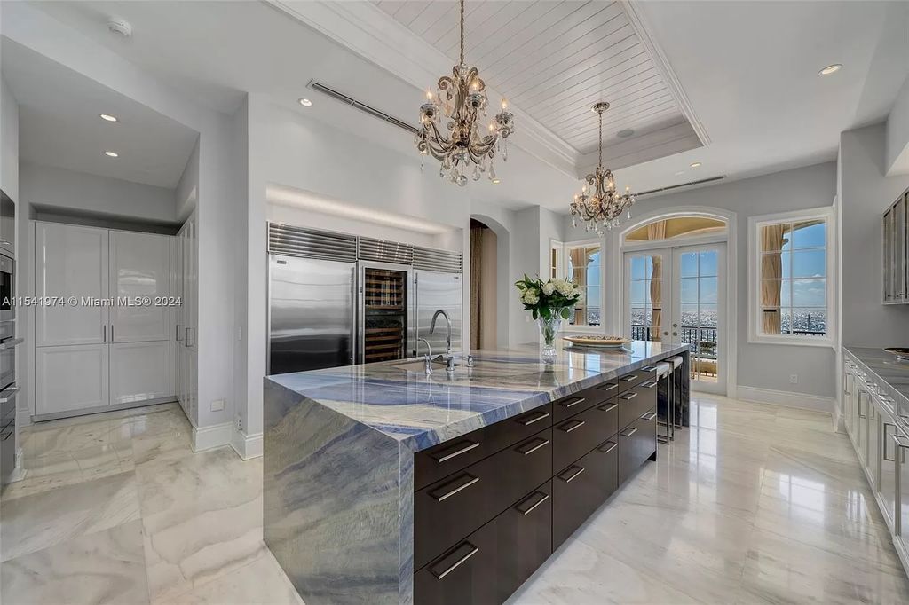 Nestled within the prestigious guard-gated community of Gables Estates, 33 Arvida Parkway presents a magnificent 14,972-square-foot estate boasting 225 feet of waterfront on a lushly landscaped 35,389-square-foot lot.